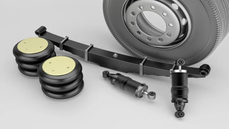 Air suspension bellows, shock absorbers, and suspension components laid out on a white background for a Range Rover repair