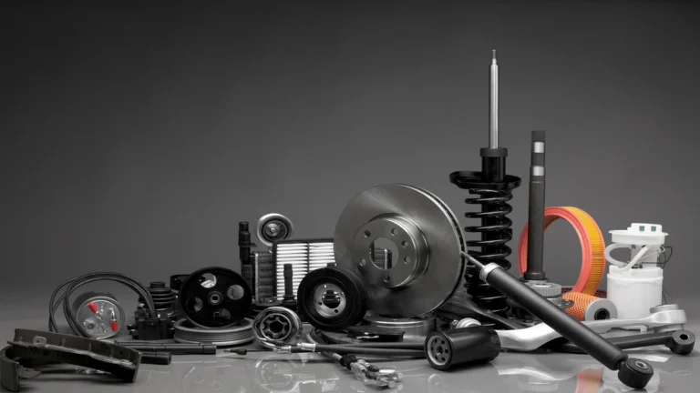 An assortment of engine and suspension components, including brake rotors and shock absorbers, displayed as Porsche spare parts.