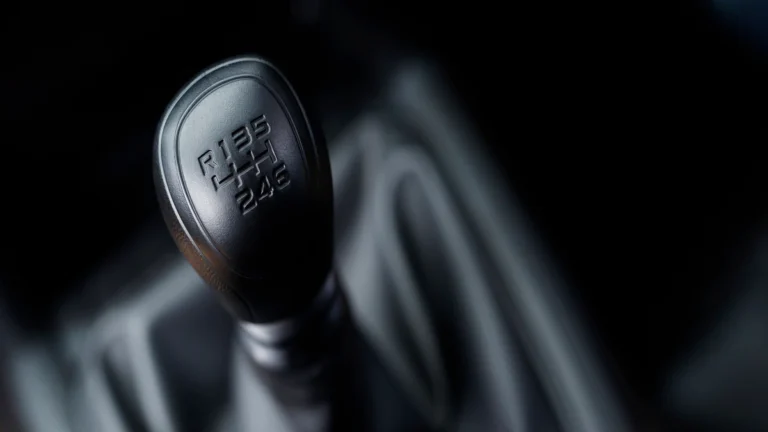 Close-up of a manual gear shift knob for a BMW gearbox.